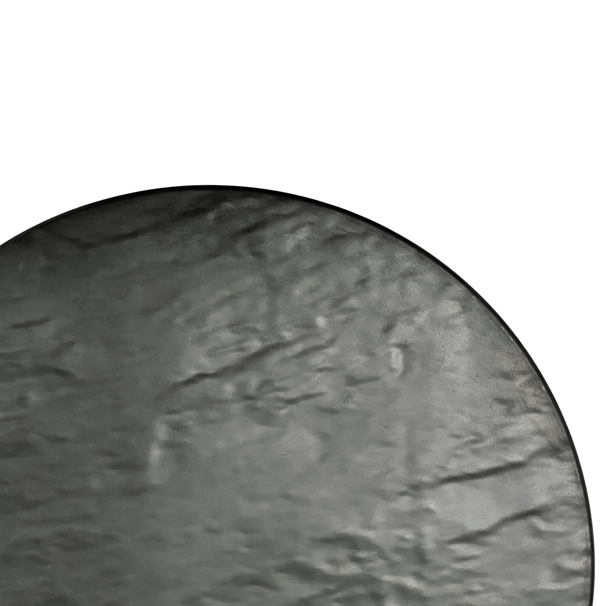 A close-up of a round, flat melamine surface with a smooth, slightly crinkled texture in gray, set against a white background. Only the lower-left portion of the circle is visible, creating a minimalist composition.