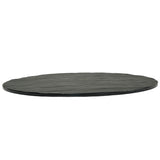 A round, flat black Frostone Collection Display Tray features a slightly uneven, textured surface and rough edges. This break resistant tray is thin and strikingly photographed from a low angle against a white background.