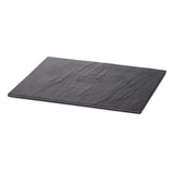 A rectangular, flat black slate display tray with rough, natural texture and subtle surface variations. The break resistant slab is photographed against a white background, positioned at an angle so both the top and one side edge are visible.