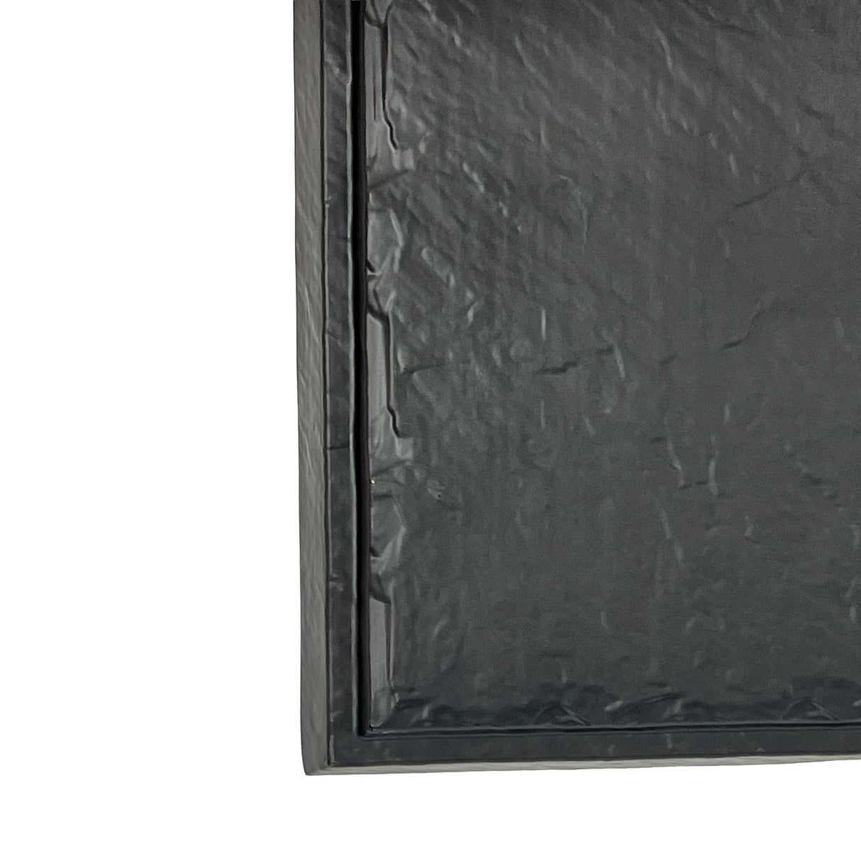 A close-up of a black padded bubble mailer, shown from the front and positioned vertically. The textured plastic surface has subtle creases, much like a break resistant melamine tray from the Frostone Collection Display Tray series.
