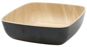 A square, shallow Frostone Naturals Bowl with rounded edges. The smooth, matte black exterior contrasts the natural light wood grain interior. This TableCraft bowl is empty and sits on a white background.