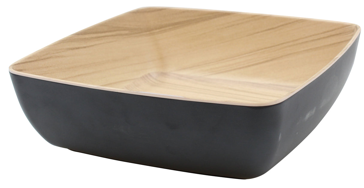 A square melamine bowl from TableCraft Products’ Frostone Naturals Bowl collection, featuring gently rounded edges. Its matte black exterior and light wood grain interior create a modern, minimalist look against a white background.