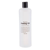 A clear plastic bottle with a black cap, labeled TableCraft Premium Honing Oil. The text states it prevents stone pore clogging and meets USP and NF standards. The bottle contains 16 fluid ounces of premium honing oil.
