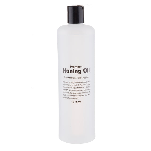 A clear plastic bottle with a black cap, labeled TableCraft Premium Honing Oil. The text states it prevents stone pore clogging and meets USP and NF standards. The bottle contains 16 fluid ounces of premium honing oil.