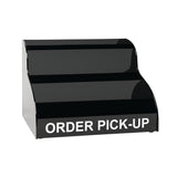 A black, two-tiered countertop display stand with ORDER PICK-UP in bold white letters on the front, designed for holding items ready for customer collection. The background is plain and white.