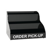 A black, two-tiered countertop display stand with ORDER PICK-UP in bold white letters on the front, designed for holding items ready for customer collection. The background is plain and white.