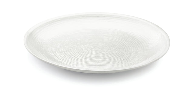 A plain, round, white ceramic plate from the Frostone Collection features a subtle textured pattern of concentric circles. Set on a white background, it is photographed at a slight angle to highlight its shallow depth and glossy surface.