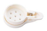 A white, round ABS plastic device with holes on top and a hinged, spring-loaded clasp on the side—likely an egg piercer or slicer. The TableCraft MPWT is dishwasher safe and shown from above against a plain white background.