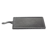 A rectangular black slate platter with a textured surface, slightly raised edges, and an extended handle featuring a small hole for hanging. Part of the Frostone Collection Serving Paddle, it’s displayed on a plain white background.