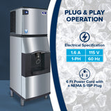 A stainless steel Vending Ice Dispenser stands on the left, using a touchless lever to dispense ice into a glass. On the right, text reads “PLUG & PLAY OPERATION” with specs and “6 Ft Power Cord with a NEMA 5-15P Plug” over an ice background.