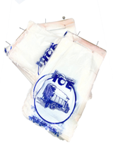 Two clear plastic milk packets with blue HCL branding and ice bag ties. Each features a traditional milk delivery cart illustration and blue text. The packets are punctured at the top and placed on a white background.