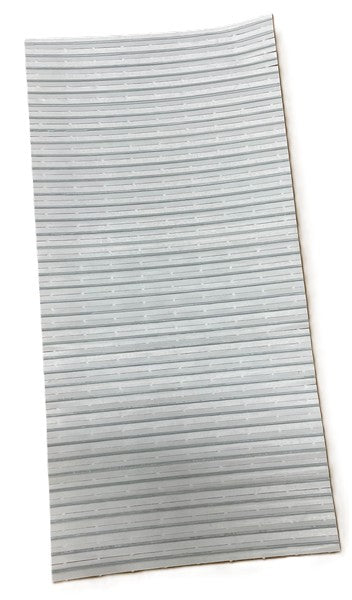 A rectangular sheet of light gray, flexible material from a Manitowoc Bag Kit with evenly spaced, thin horizontal ridges. Photographed against a white background, the sheet appears slightly curved along its length and is used for ice bag ties.