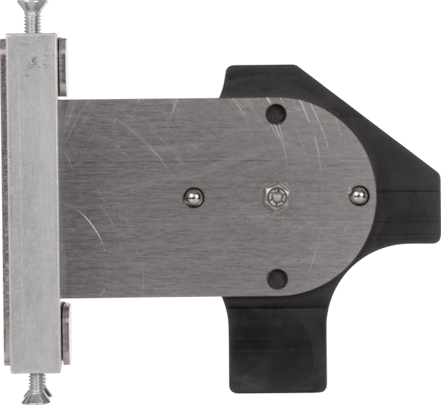 A close-up view of a flat, brushed metal Rotary Gap Adjustment Bracket with rounded edges, attached to a black plastic component. The assembly is secured with bolts and a hex screw. On the left, part of a Vulcan GADJUST-ROTARY bar appears.