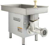A Hobart Meat Grinder with a powerful 3 HP motor features a large rectangular stainless steel pan on top, a plastic plunger handle, metal grinding unit, and perforated output plate. The Hobart logo is displayed on the side of its sturdy four-legged frame.