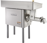 A large, industrial Hobart Meat Grinder crafted from stainless steel stands on four legs. It features a rectangular feed tray, powerful 5 HP motor housing with the Hobart logo, and a horizontal grinding attachment with a dispensing chute.