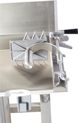 A close-up of a Hobart 6801-18IP stainless steel sausage stuffer with an integrated pusher, featuring a handle, gears, and triangular metal teeth on a sliding mechanism atop a shiny metal surface with clean, industrial lines.