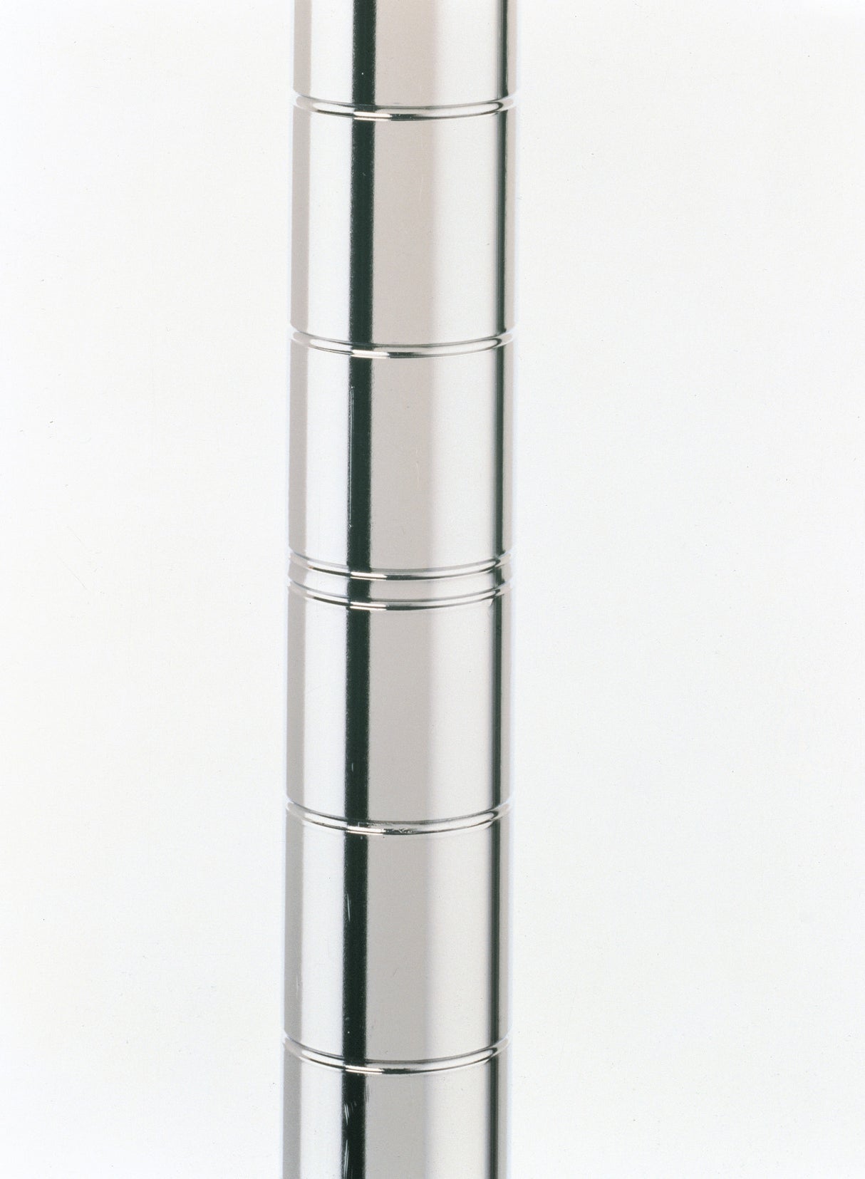 A shiny, cylindrical Super Erecta SiteSelect Post made of type 304 stainless steel with horizontal grooves at regular intervals stands against a plain white background. The grooves create a segmented look along the smooth metallic surface. Only part of the pole is visible.