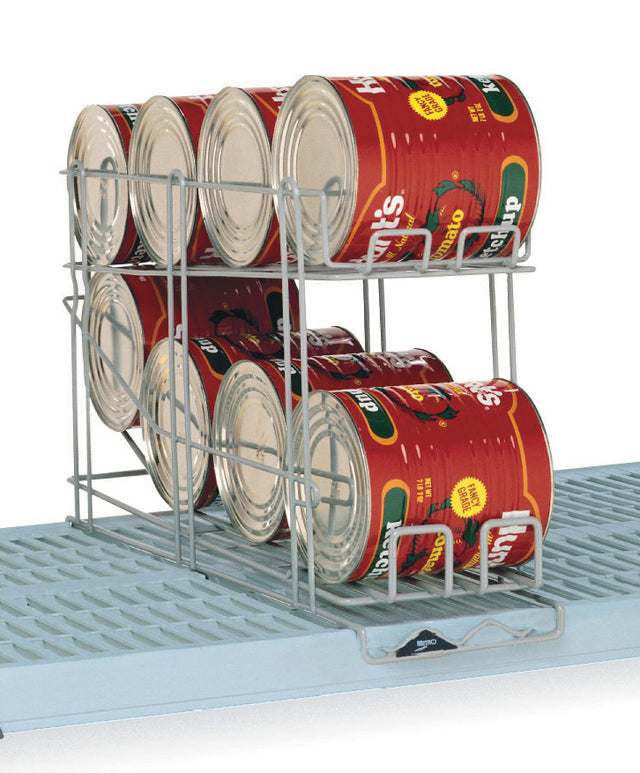 A corrosion-resistant can rack holds eight large tomato cans in two rows on blue Metro shelves. The rack allows cans to roll forward for easy access, and the cans are labeled “Hunt’s” with images of tomatoes.