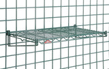 A Metroseal 3 green SmartWall Flat Grid Shelf is mounted on a matching green grid wall panel. The rectangular shelf features a metal lattice design with antimicrobial protection, held by two angled brackets and a small red and white label in front.