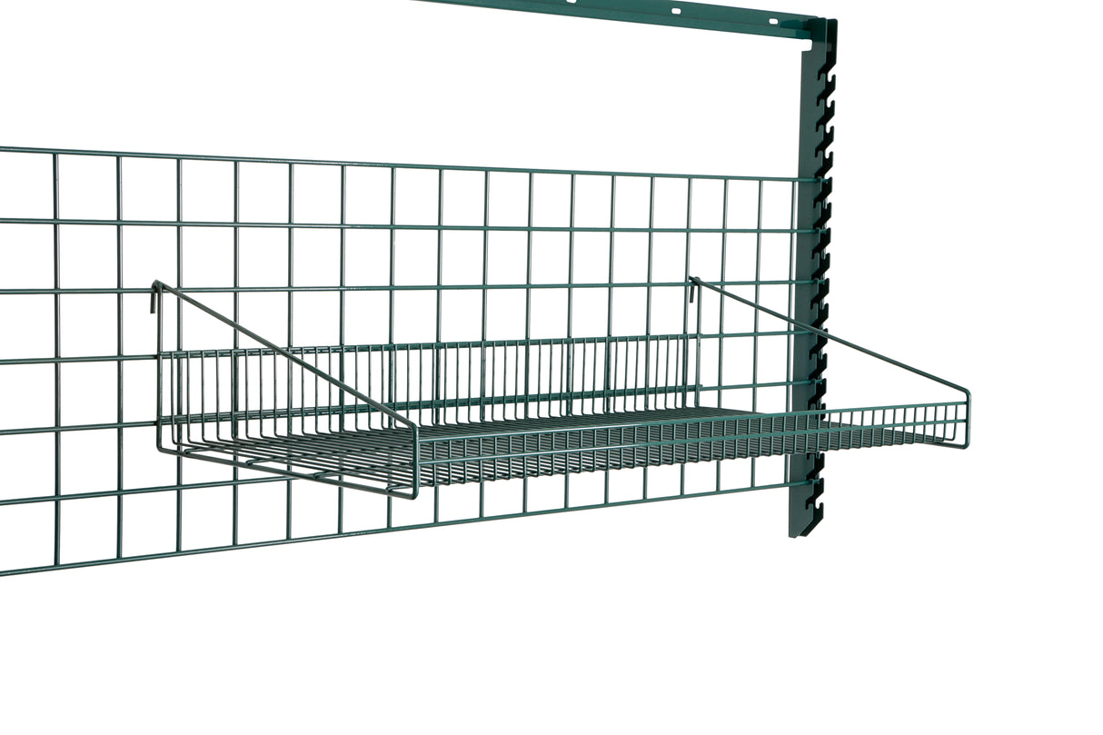 A metal wire SmartWall Grid Shelf is mounted on a green grid wall panel with a vertical support bar. The rectangular, epoxy-coated shelf is open at the top, attached with angled arms—ideal for organizing items off the ground.