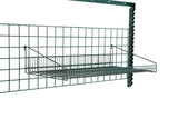 A metal wire SmartWall Grid Shelf is mounted on a green grid wall panel with a vertical support bar. The rectangular, epoxy-coated shelf is open at the top, attached with angled arms—ideal for organizing items off the ground.