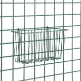 A rectangular epoxy-coated metal wire basket is attached to a grid-style wire wall. The SmartWall Storage Basket is empty, featuring thin, evenly spaced rods; both basket and wall are dark green. The background remains plain and uncluttered.