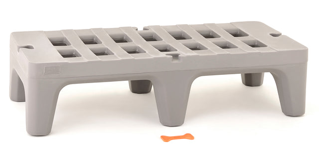 A gray, rectangular plastic step stool, similar to a small NSF dunnage rack, features four wide legs and a grid-patterned top on a white background. In front of the stool lies a small orange bone-shaped object.
