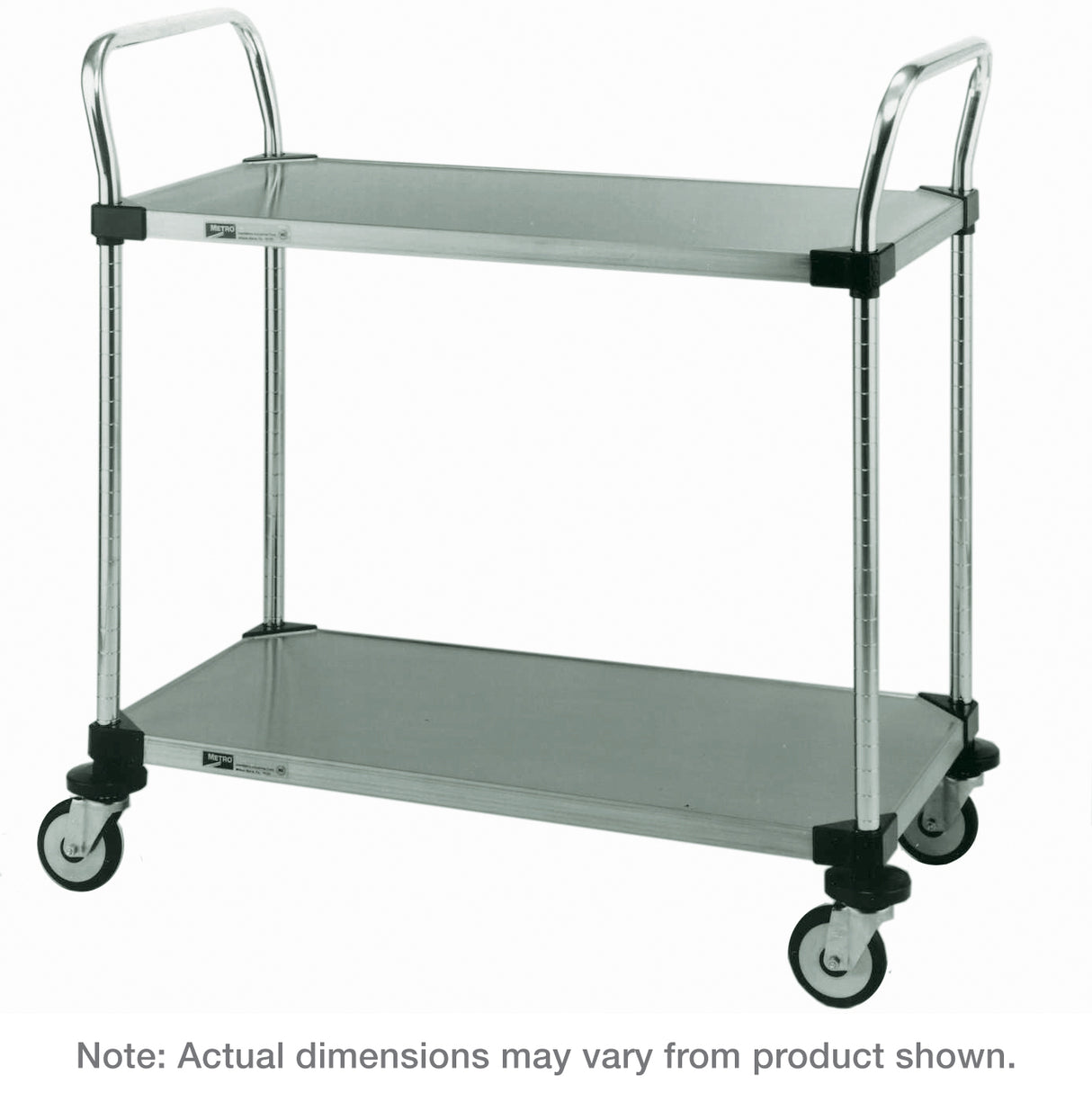A two-tiered Metro MW105 stainless steel utility cart with four swivel caster wheels and upright handles on both ends. Both shelves are flat and rectangular. Caption: “Note: Actual dimensions may vary from product shown.”.