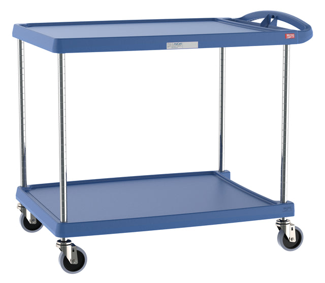 A blue utility cart with chrome legs and four swiveling caster wheels. The two rectangular, heavy duty plastic shelves have raised edges and feature Microban antimicrobial protection. A handle on one end allows for easy pushing or pulling.