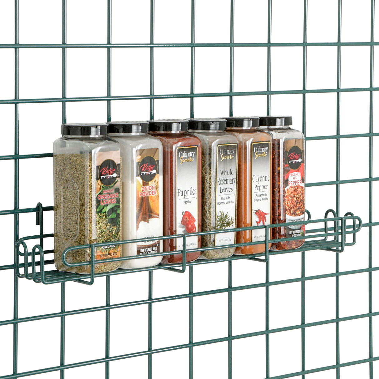Five rectangular spice jars with black lids sit in a Metroseal 3 wire rack, featuring antimicrobial protection, attached to a green grid wall. The jars are labeled: Italian Seasoning, Onion Powder, Paprika, Whole Rosemary, and Cayenne Pepper.
