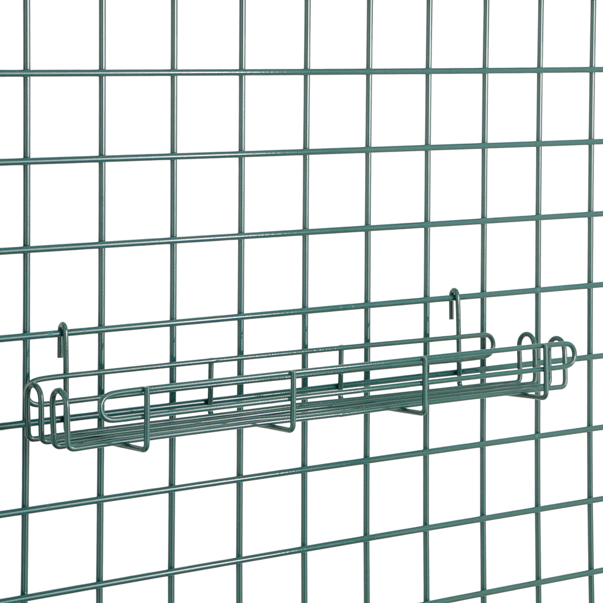 A Metroseal 3 SmartWall Grid-Mount Spice Rack is shown as a rectangular wire basket shelf on a metal grid panel. The greenish-gray finish offers antimicrobial protection, and the shelf secures to the grid by hooks at each end.