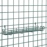 A Metroseal 3 SmartWall Grid-Mount Spice Rack is shown as a rectangular wire basket shelf on a metal grid panel. The greenish-gray finish offers antimicrobial protection, and the shelf secures to the grid by hooks at each end.
