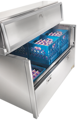 A large Stainless Steel Milk Cooler drawer is pulled open, revealing blue plastic crates filled with single-serve milk cartons arranged neatly inside. The top lid of the unit is also open, showing the organized storage system.