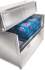 A large stainless steel milk cooler with top-mount refrigeration stands open, revealing two blue crates filled with neatly stacked cartons of milk. The unit features sturdy handles and a sleek, industrial design.