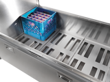 A blue crate sits inside a stainless steel milk cooler, featuring top-mount refrigeration for optimal cooling.