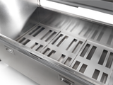 A close-up view of an open, empty stainless steel container with a hinged lid, reminiscent of a milk cooler. The interior features three removable metal trays with evenly spaced rectangular slots. The surface is clean, reflective, and industrial in design.