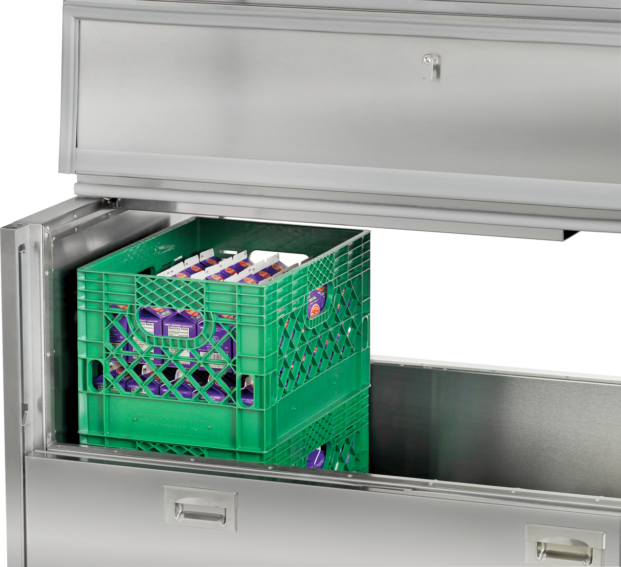 A green crate sits in a drawer beneath a Traulsen milk cooler.