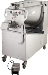 A large, industrial Hobart prime mixer grinder made of stainless steel with a tilted mixing tub, control panel, handles, wheels, and foot pedal, designed for heavy-duty food processing in commercial kitchens or butcher shops; 150 lb capacity.