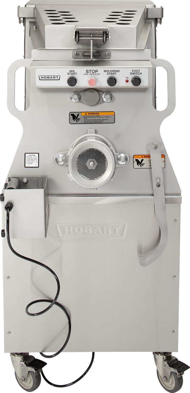 A commercial Hobart Mixer Grinder with 200 lb. capacity stands on wheels. The front features labeled buttons, switches, warning stickers, a circular grinding plate, and a metal chute. A black cord hangs left; a large handle sits right.