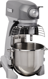 A large, commercial-grade planetary mixer in gray with a metal 20 quart mixing bowl attached. The bench mixer features a protective wire guard and a control knob on the front, making it ideal for sturdy, industrial bakery or restaurant use.