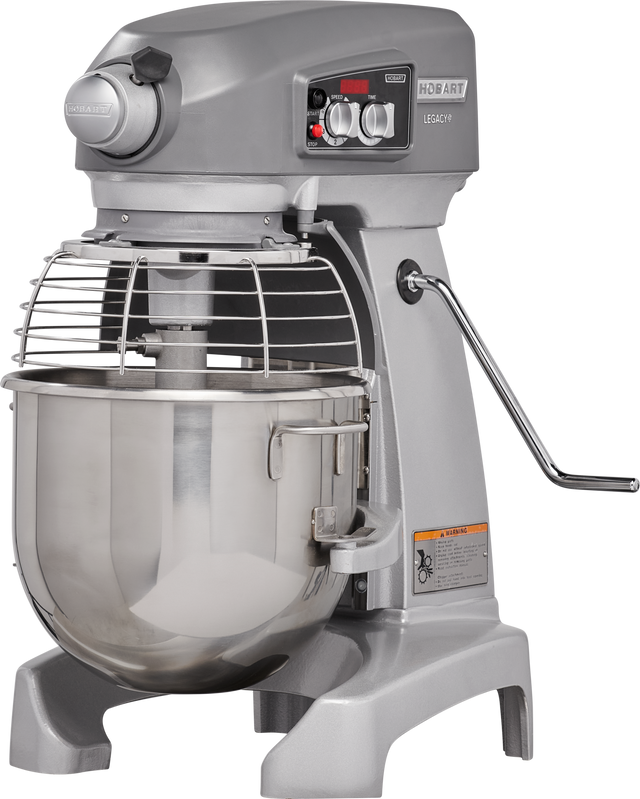 A large industrial floor type mixer with a stainless steel bowl, protective wire guard, control knobs, and levers. The machine has a sturdy base and side handle for adjusting the bowl position. The brand “Hobart” and model “Legacy+” are visible.