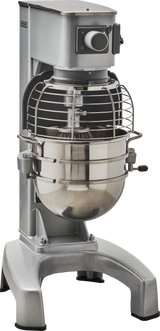 A large industrial planetary mixer with a metallic silver finish, wire safety guard, control knob, and a stainless steel mixing bowl attached. This sturdy 30 quart mixer is ideal for commercial kitchens or bakeries with its wide base and functional design.