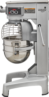 A Hobart Legacy planetary mixer, labeled Hobart HL300, with a 30 quart stainless steel bowl and wire safety guard. This commercial stand mixer boasts control dials, a sturdy metal base, and side lever for heavy-duty use in professional kitchens.