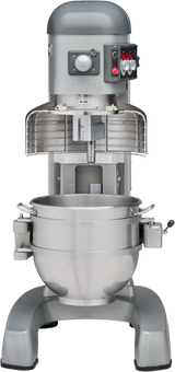 A large 60 quart planetary mixer with a metallic finish, featuring a protective wire guard, control panel with switches, and a stainless steel mixing bowl secured on a sturdy base. The commercial dough mixer is set against a plain background.