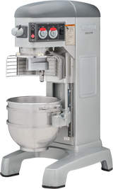 A large Hobart HL600C 60 quart mixer in gray and silver, featuring control knobs, safety guard, and a metal mixing bowl. Its sturdy, industrial design is ideal for mixing dough or batter in bakeries or large kitchens.