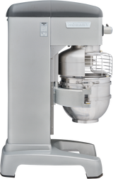 A large, industrial Hobart planetary mixer in silver, featuring a metal mixing bowl, safety guard, and sturdy base. This 60 quart mixer is designed for heavy-duty food preparation in commercial kitchens.