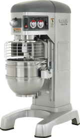A large industrial 60 quart mixer with a metal bowl, safety guard, and control panel. Labeled “Hobart Legacy,” this silver and gray planetary mixer is ideal for commercial food preparation, featuring sturdy legs and a variety of switches and dials.
