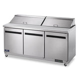 The Arctic Air AST72R is a large, commercial stainless steel refrigerator with three doors and two top lids, ideal as a salad or sandwich prep table. Sleek design features black handles, a bottom-right control panel, and convenient wheels for mobility.