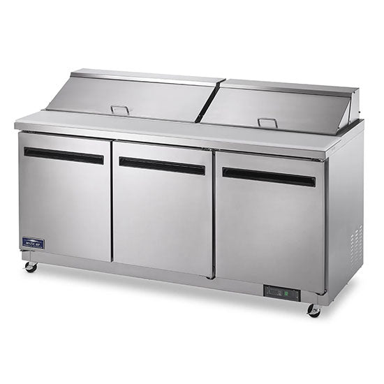 The Arctic Air AST72R is a large, commercial stainless steel refrigerator with three doors and two top lids, ideal as a salad or sandwich prep table. Sleek design features black handles, a bottom-right control panel, and convenient wheels for mobility.