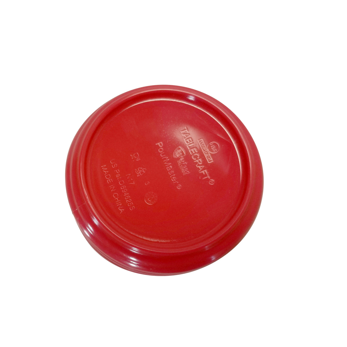 A red, round plastic lid is shown upside down on a white background. It features embossed text with branding and usage instructions, including TABLECRAFT, PourMaster Low Profile Top, dishwasher safe details, and MADE IN CHINA.